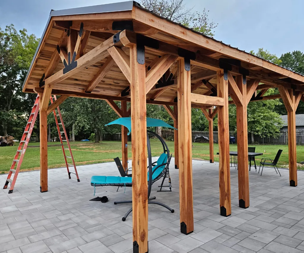 Cedar pergola standing over a paver patio