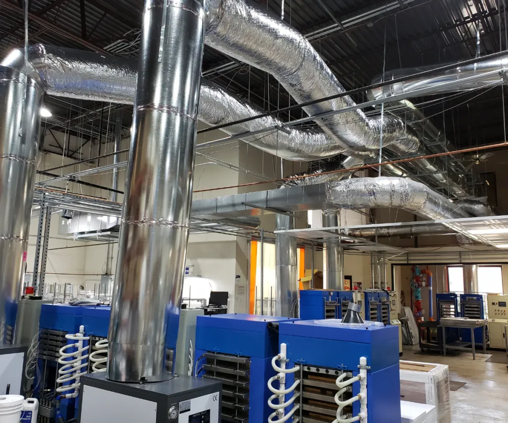 Commercial shop interior with exposed ductwork and equipment