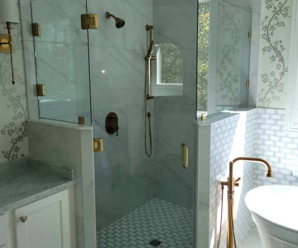 Frameless glass shower enclosure in a finished bathroom