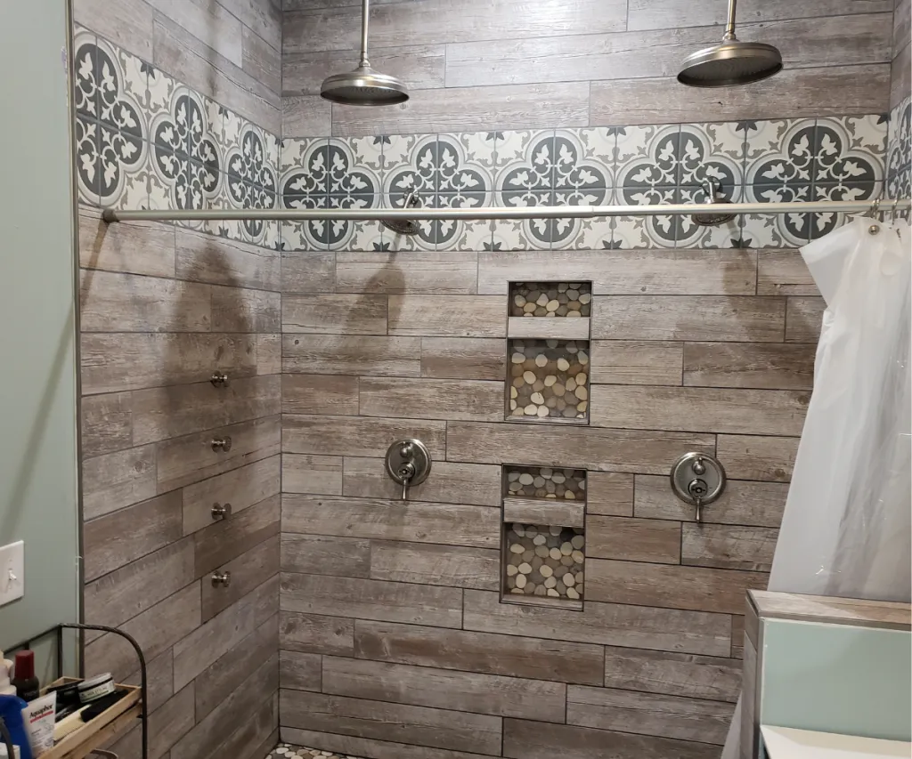 Shower tiled in wood-look plank tile with two built-in niches